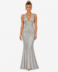 Front view of the Virelle silver sequin halter maxi dress with a plunging neckline and flared hem.